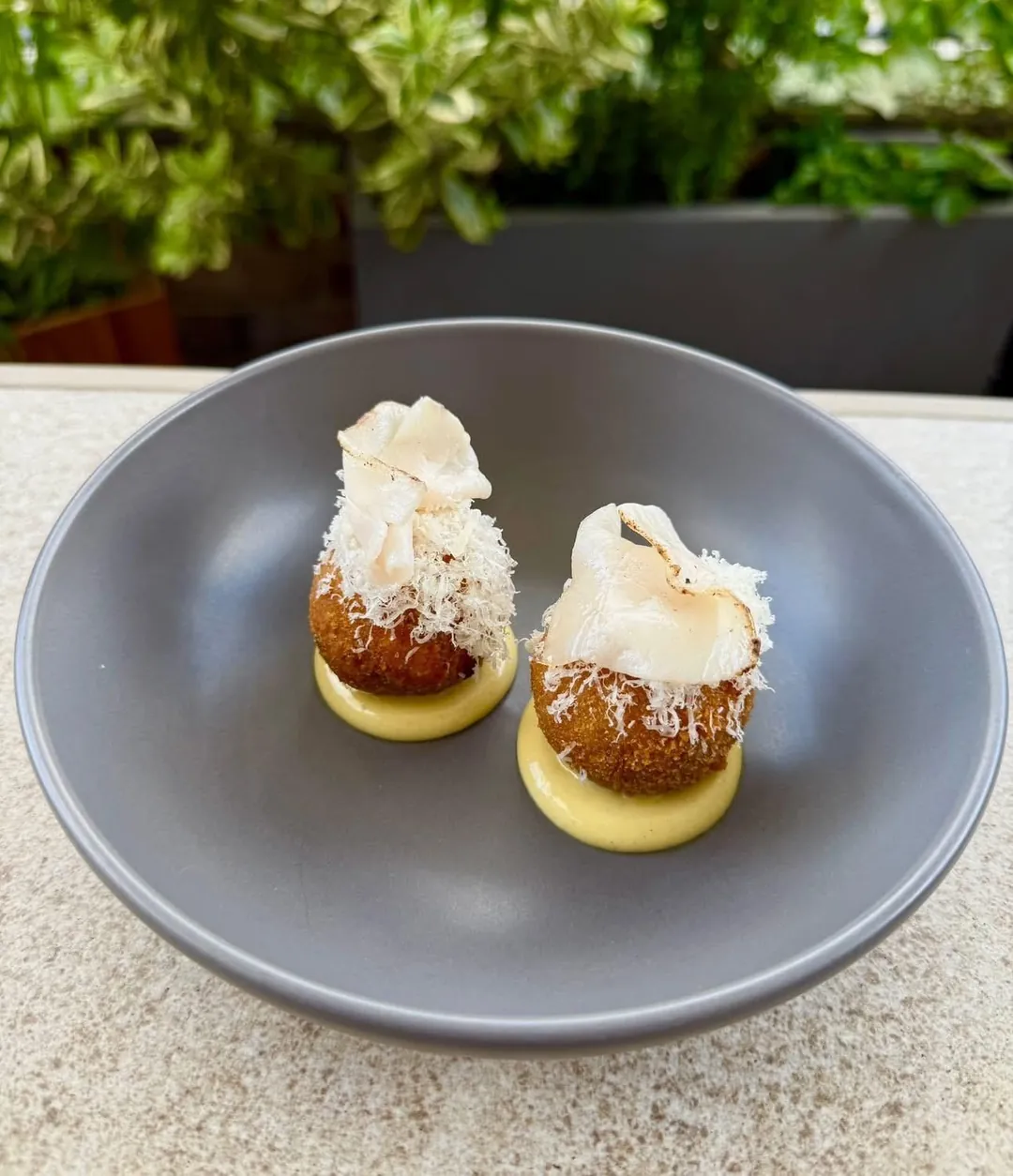 Two croquettes on a grey plate
